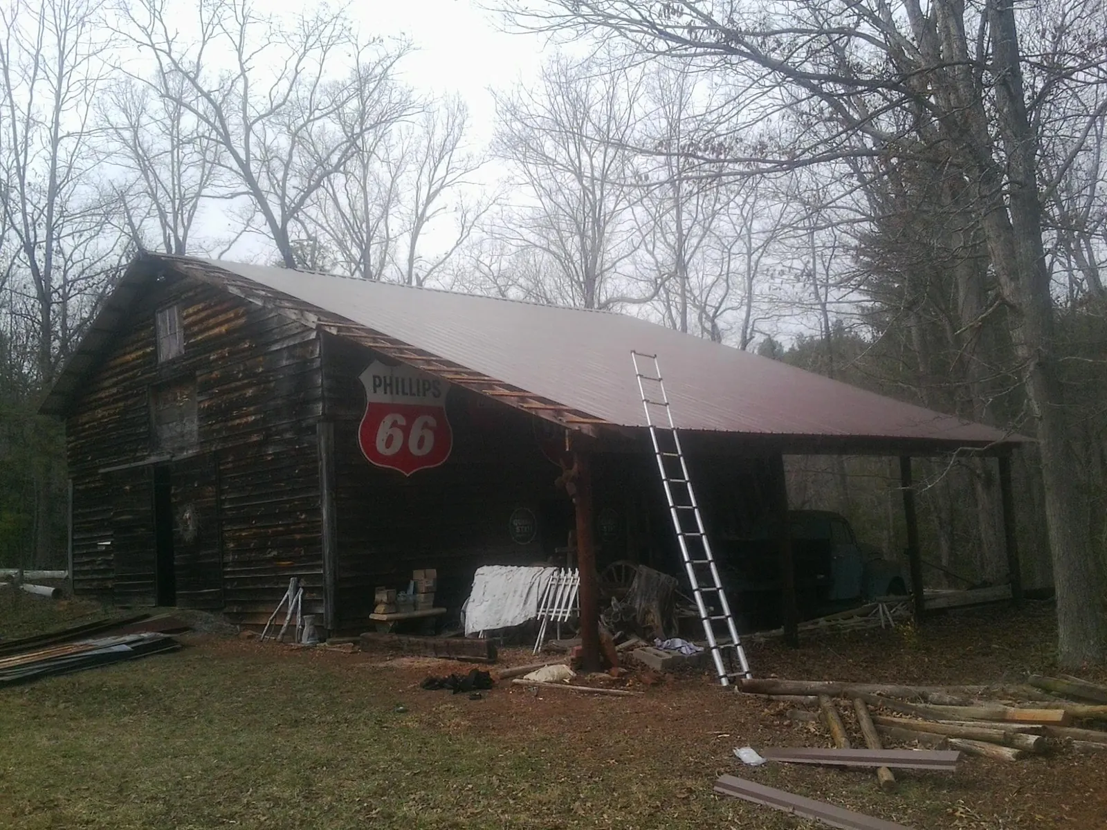 New metal roof on an open sided timber barn with a vintage sign in Chadds Ford