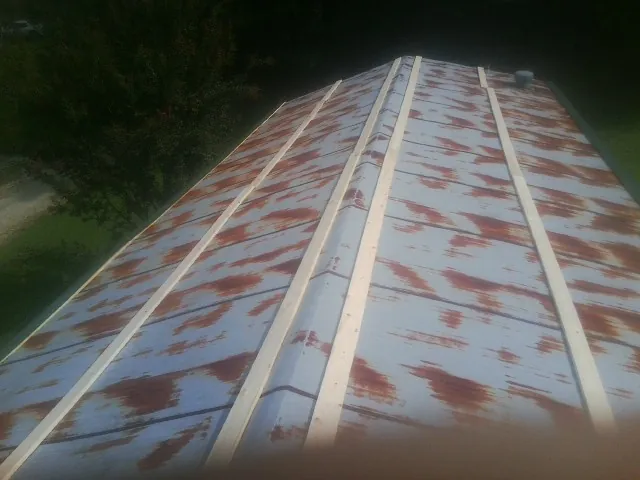 Rusted metal roof panels with new wood purlins before replacement — Storm Damage Roof Repair in Chadds Ford by Roofing Brothers