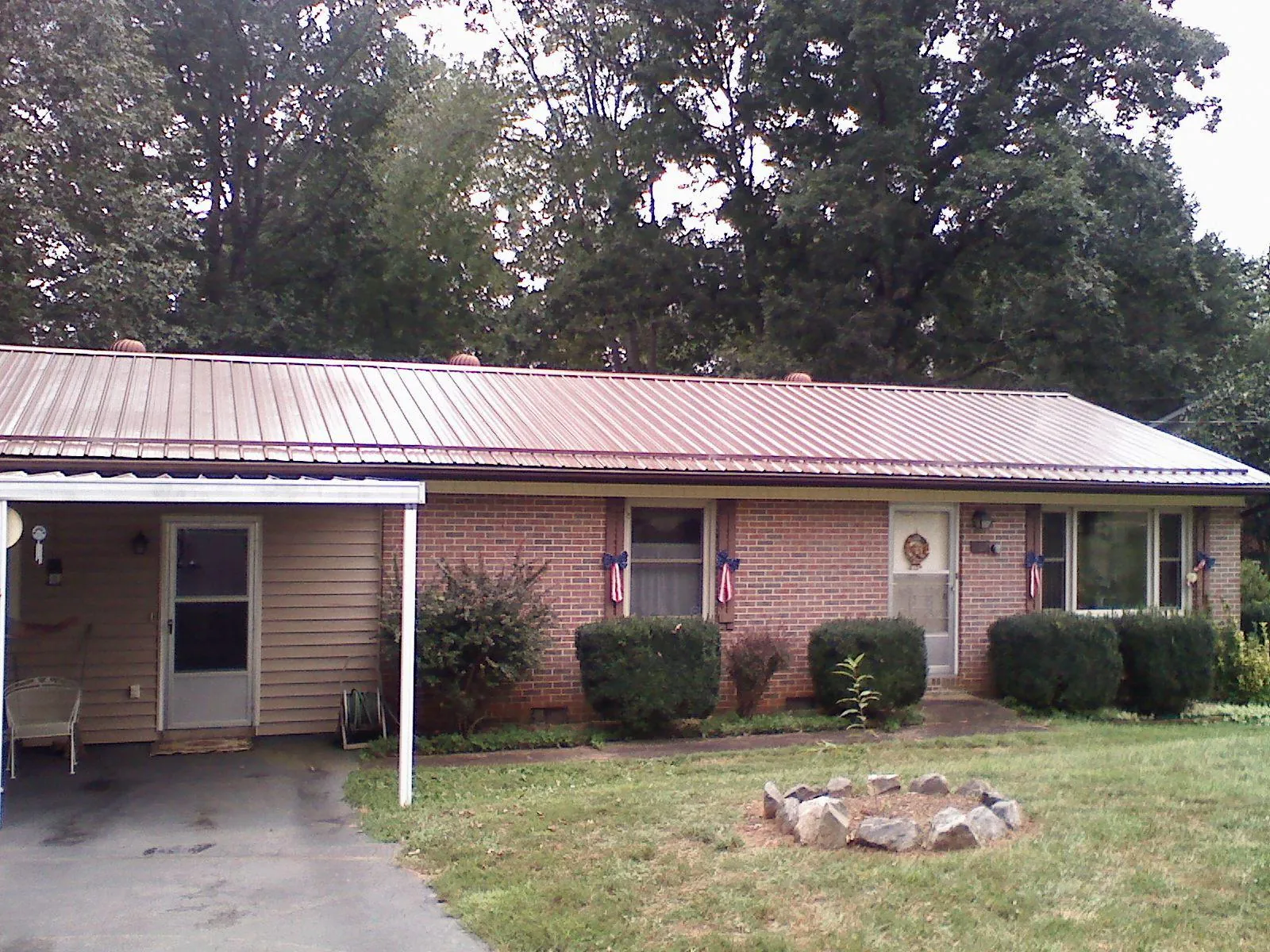 Bronze metal roof and carport on a brick ranch home — Roof Repair work by our crew in Chadds Ford